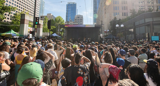 Hundreds of people enjoying a concert in Downtown Seattle during the Downtown Summer Sounds concert series