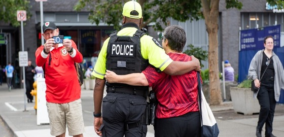Officer taking picture with person