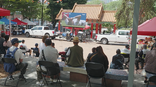 Fans watching a soccer match in Seattle's Chinatown-International District