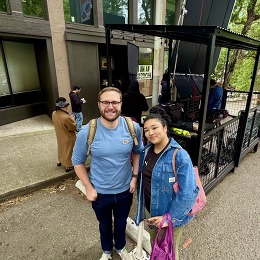 Two smiling people at I Am American film set