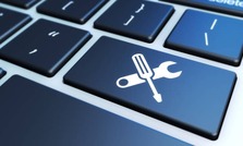 Close up of laptop keyboard with a Screwdriver and Wrench crossed over as a sticker on the enter key