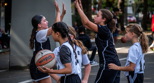 Kids playing basketball and giving high-fives