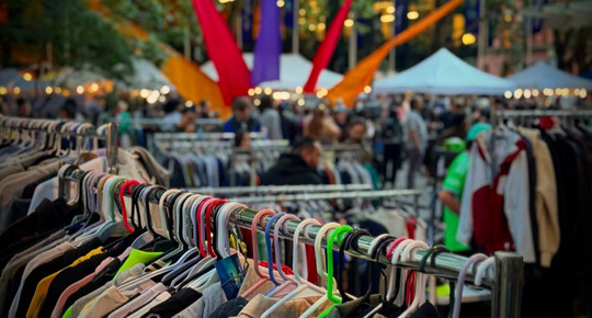 People browsing through closing racks at the Occidental Square Flea Market