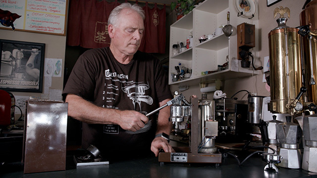 William Stiles repairs an espresso machine.