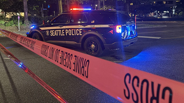 A Seattle Police vehicle with red crime tape.