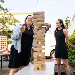 Two people laughing and playing Jenga