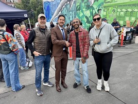 OED Director smiling with crew members at film set production
