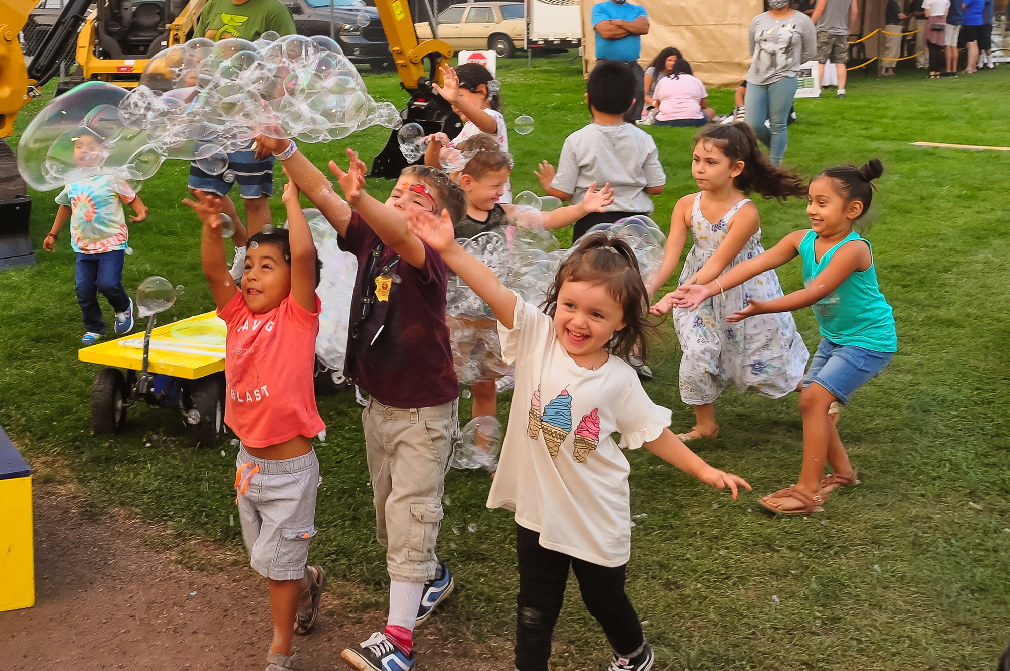 Kids playing with bubbles at fair