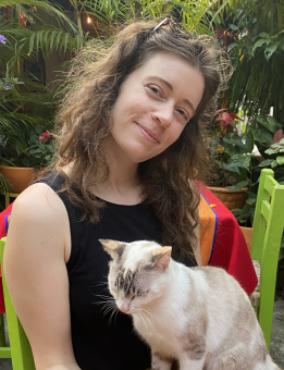 Halee Sexton, new Natural Resources Intern, sitting with a cat on her lap.