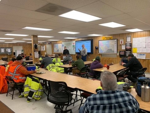 Picture of workcrew morning meeting about snowstorm