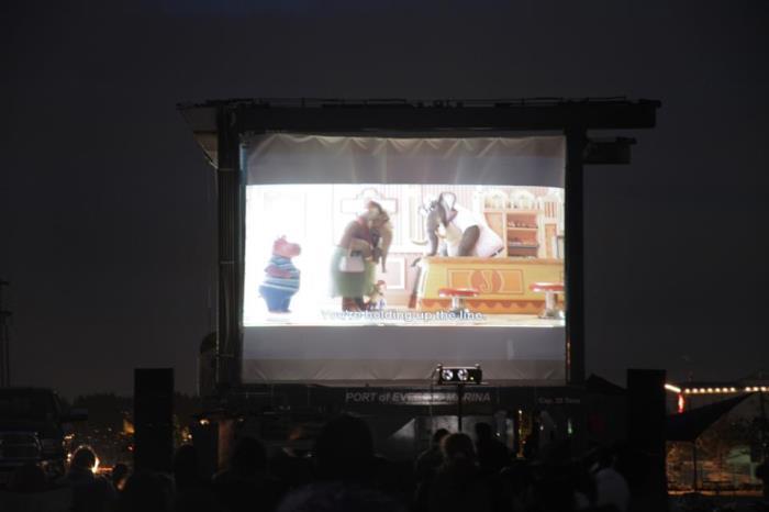 Movie being shown on projector screen.