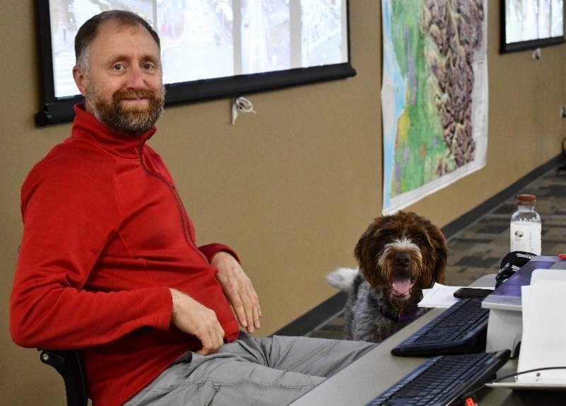Snohomish County DEM Director Jason Biermann with Lucy, one of the dogs that regularly visits the Emergency Coordination Center