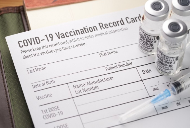 COVID-19 vaccine on top of COVID-19 vaccination record card