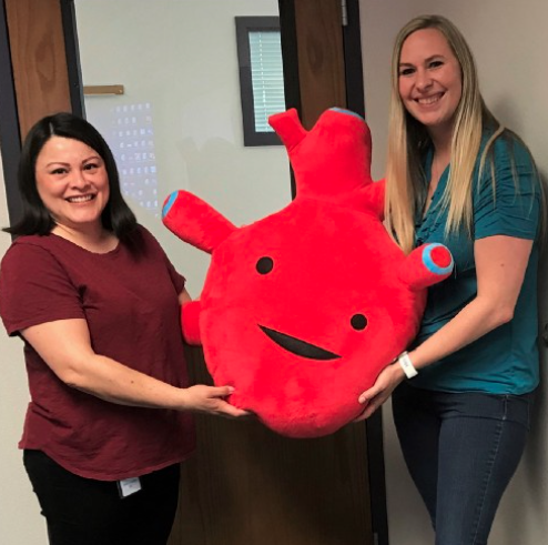 Nurses celebrate heart health awareness month with a stuffed cloth heart