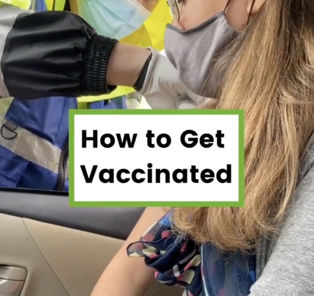 Photo from video of person getting vaccinated at drive-thru site