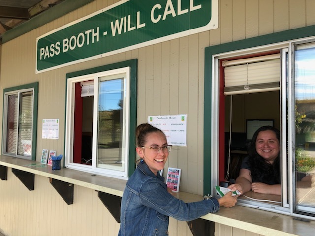 A person gets a ticket at the fair pass booth