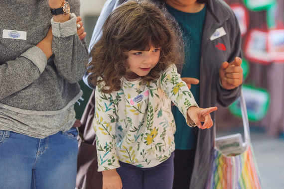 A child points at an exhibit at the Evergreen State Fair