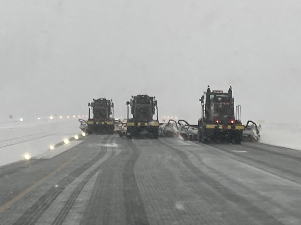 Snow brooms in echelon formation on main runway at Paine Field