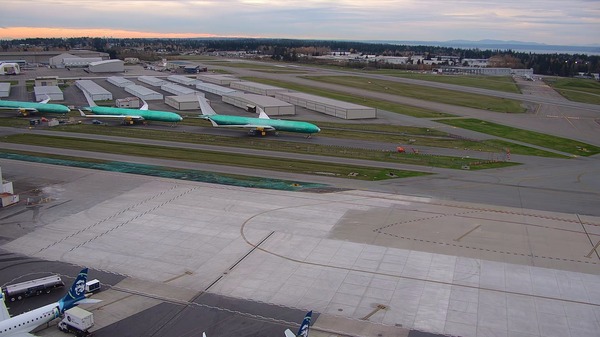 Completed terminal area ramp project with new concrete poured and sealed with Boeing 777X aircraft in the background