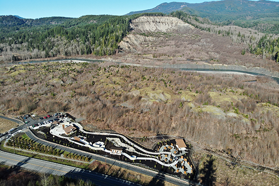 An aerial view of the SR 530 Slide Memorial with the landslide scar in the background.