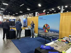 Administrative Assistant Katie WIgestrand engages with a local pilot at the Northwest Aviation Conference and Trade show