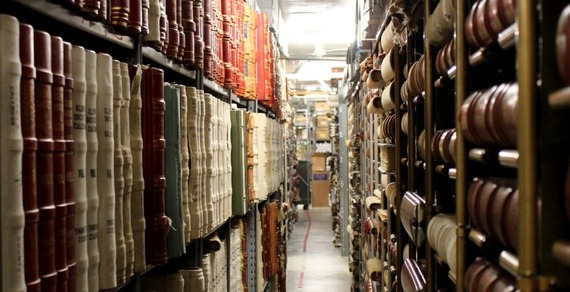 Rows of old archived documents on shelves