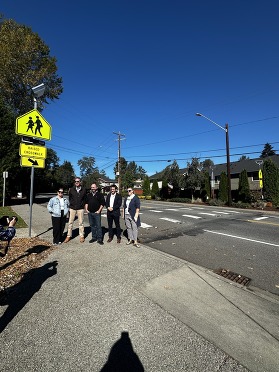 Staff and parents stand outside of newly installed crosswalk at Lockwood Elementary