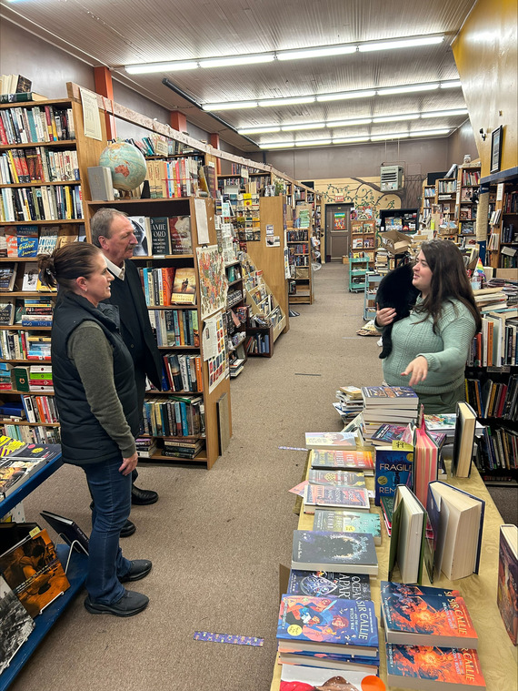 Executive Somers and Mayor Cudaback talk with a business owner at a book store on Main Street in Monroe
