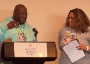 Chief DEI Officer for Snohomish County at podium speaking at Step Up conference with other LSC speaker