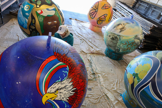 Five large buoys painted with various designs 