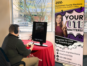 Elections banner your vote matters with snoco.org/elections 425-388-3444 #SnoCoVOTES email: elections@snoco.org individual using AVU device to vote