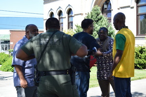 Gathered together Black community members talking amongst each other