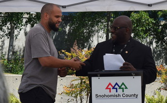 Everett business owner Craig Chambers shaking hands with Wil Johnson the Chief DEI Officer for Snohomish County