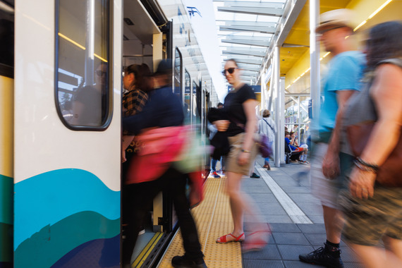 People boarding a light rail train