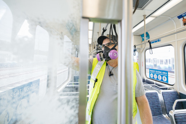 Employee cleaning a Light rail vehicle. 