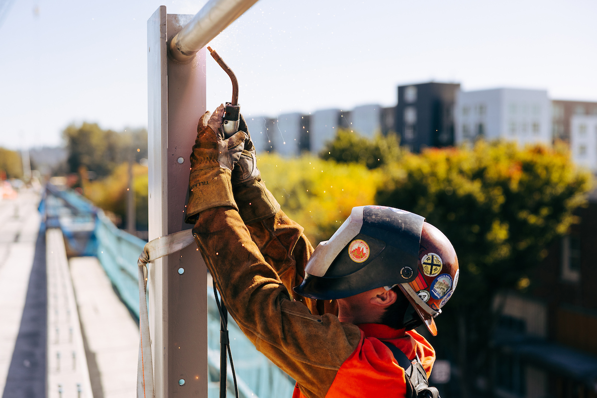Crew member performing work on the elevated guideway at the future Downtown Redmond Station