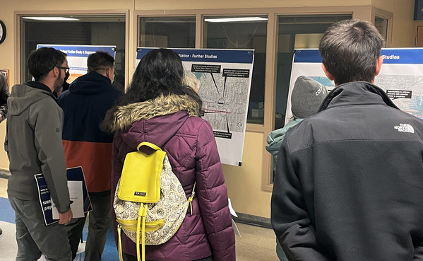 Photo of people looking at an information display, West Seattle and Ballard Link Extensions