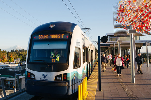 Image of Passengers board and exit a Link light rail train on an elevated platform, Everett Link Extension Project update header image
