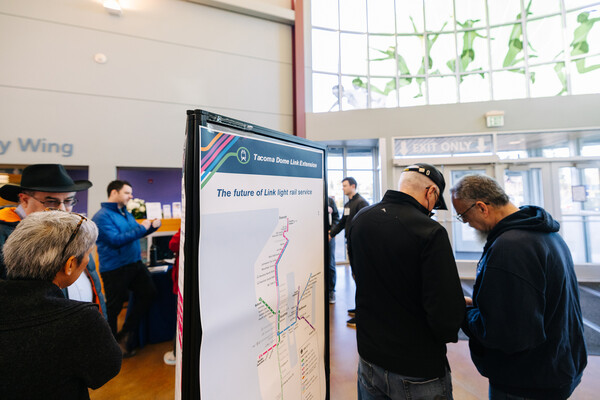 Photo of people viewing an online open house information display for Tacoma Dome Link Extension