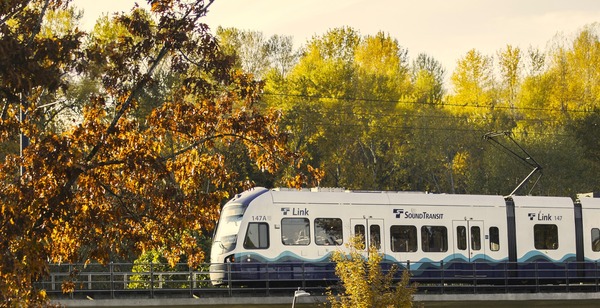 photo of link light rail with trees in the background