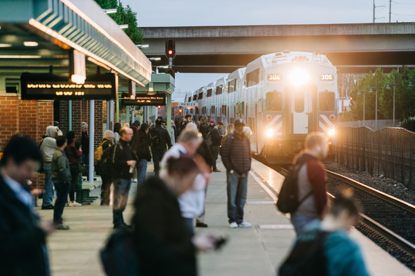photo of Sounder Train arriving at Auburn Station with waiting on the platform