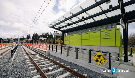 photo of 2 Line train tracks with the phrase "safe 2 travel" on the bottom right corner