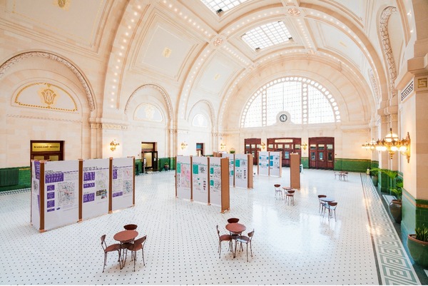An overhead view of Union Station in the Great Hall with poster displays, and small tables set up for the South Downtown Hub Open House event.