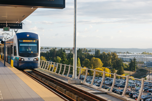Sound Transit Link light rail on elevated tracks leaves an elevated station.