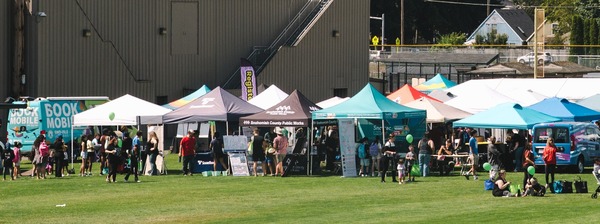 Photo of the Sound Transit booth, among other booths at MarinerFest.