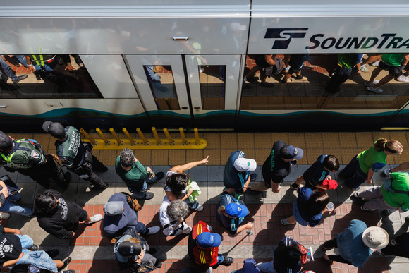 Soccer fans walk along the Chinatown/International District Station Link light rail platform to a Club World Cup match in summer 2025.