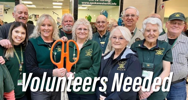 Volunteers in green shirts gathered for a photo