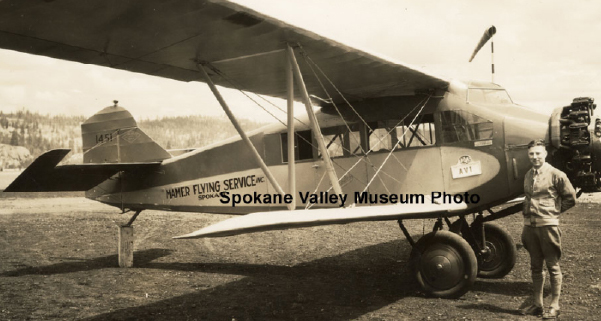 Historic photo from the Spokane Valley Heritage museum of a man and his plane