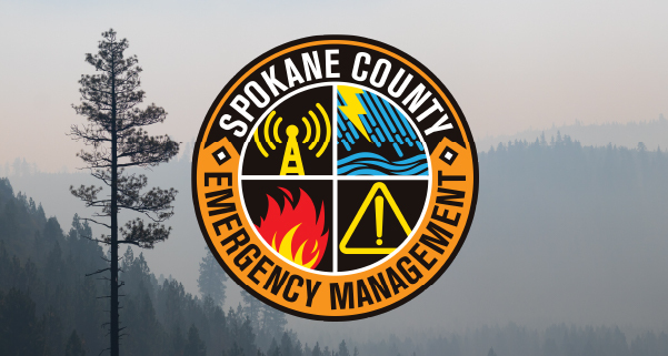 A smoky forest with the logo for Spokane County Hazard Mitigation Plan overlaid on it.