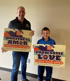 Garyn and Hines Holding Vision Zero Signs